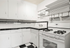 Charming kitchen with a classic black and white design, featuring ample cabinet space and a modern gas stove.