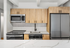 Modern kitchen with sleek stainless steel appliances, light wood cabinetry, and elegant marble countertops.