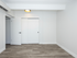 Bright and modern room with elegant wood flooring and clean white walls, perfect for a serene living space.