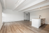 Bright, open-concept living space with sleek wood flooring and modern kitchen island.