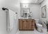Modern bathroom with elegant wooden cabinetry, sleek black fixtures, and minimalist decor.