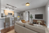 Modern open-concept living room with sleek kitchen, cozy seating, and stylish decor, perfect for relaxation and entertainment.