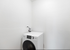 Bright laundry room with a sleek, modern washing machine, perfect for efficient cleaning.