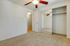 Bright, spacious bedroom with plush carpet, ceiling fan, and mirrored closet doors.