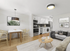 Modern open-concept living space featuring a stylish kitchen with hexagonal backsplash, cozy dining area, and comfortable seating. Bright and airy atmosphere with chic decor.