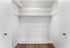 Spacious walk-in closet with modern shelving and sleek wooden floors.