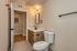 Modern bathroom with elegant lighting, stylish wooden vanity, and polished fixtures.