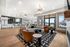 Elegant open-concept living area with stylish modern decor, featuring plush seating, chic lighting, and a spacious kitchen with bar seating.