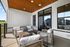 Charming outdoor patio with modern wicker seating, overlooking scenic views and featuring a stylish wood-paneled ceiling.