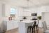 Modern kitchen with sleek white cabinetry, stainless steel appliances, and an inviting island with stylish seating.
