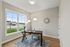 Bright and inviting home office with a large window view, stylish furniture, and modern decor.