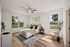 Bright and airy bedroom with elegant decor, featuring large windows, a plush bed, and stylish furniture.