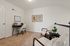 Chic home office nook with modern desk, plush chairs, and vibrant artwork, perfect for productivity and relaxation.