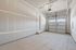 Spacious garage with modern door, ample lighting, and premium drywall finish.