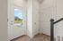 Welcoming modern entrance with natural light and sleek wooden flooring, offering a glimpse of the vibrant outdoors.