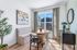 Bright and cozy dining nook with modern decor, featuring a round wooden table, chic chairs, and large window for natural light.