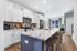 Modern kitchen with sleek white cabinets, stainless steel appliances, and a spacious marble island, perfect for culinary creativity and entertaining.