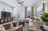 Bright and inviting living room featuring a cozy sectional sofa, stylish decor, and large windows with scenic views.