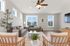 Bright and inviting living room with large windows, elegant neutral decor, and cozy seating area.