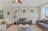 Bright and inviting living room with modern furniture, natural light from multiple windows, and elegant decor.