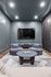 Elegant living room with modern circular chairs, a sleek coffee table, and a large flat-screen TV, creating an inviting entertainment space.