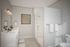 Modern bathroom interior showcasing a sleek double sink vanity and a glass-enclosed shower.