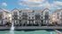 Chic townhouse community with modern architecture, featuring spacious balconies overlooking a serene pond with a fountain, ideal for urban living.