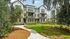 Charming modern apartment complex with lush landscaping and inviting balconies, perfect for stylish living.