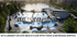 Luxurious on-site beach club with sparkling pools, chic lounge chairs, and vibrant umbrellas, offering exquisite food and beverage service near a scenic lake.