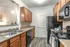 Kitchen with Maple Cabinets and Black Appliances at Abberly Place Apartments in Garner, NC