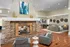 Resident clubhouse featuring a central double-sided stone fireplace and cozy seating areas at Abberly Place Apartments in Garner, NC