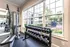Gym with dumbbells and weight bench at Abberly Place Apartments in Garner, NC.