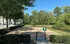Dog park with agility equipment and shaded benches at Abberly Place Apartments in Garner, NC