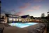 Resort Style Swimming Pool at dusk at Abberly Liberty Crossing Apartments in Charlotte, NC