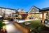 Courtyard featuring cornhole, covered patio tables, and ample lounge chairs at Abberly Liberty Crossing Apartments in Charlotte, NC