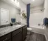 Modern bathroom with a sleek bathtub and stylish fixtures at Abberly Liberty Crossing Apartments in Charlotte, NC