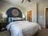 A bedroom featuring a bed and a prominent blue accent wall with large closet at Abberly Liberty Crossing Apartments in Charlotte, NC