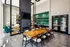 Clubhouse with a long conference table and a mounted TV on the wall at Abberly Liberty Crossing Apartments in Charlotte, NC