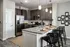 A stylish kitchen with stainless steel appliances, granite countertops, and plenty of natural light at Abberly Liberty Crossing Apartments in Charlotte, NC