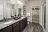 A modern bathroom featuring sleek fixtures, a shower, a sink, and a toilet at Abberly Liberty Crossing Apartments in Charlotte, NC