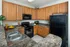 Kitchen With Double Sink and Black Appliances at Abberly Village Apartments in West Columbia, SC
