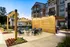 Patio with tables, chairs, and a wooden privacy wall at Abberly Liberty Crossing Apartments in Charlotte, NC