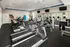 Fitness Room with Cardio Equipment and TVs at Abberly Pointe Apartments in Beaufort, SC