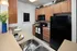Kitchen Featuring Black Appliances and Maple Cabinets at Abberly Pointe Apartments in Beaufort, SC