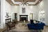 Elegant clubroom featuring a high ceiling, a cozy black fireplace, and large arched windows allowing natural light to brighten the space at Abberly Woods Apartments in Charlotte, NC