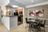 Kitchen with Bar and Dining Area at Abberly Woods Apartments in Charlotte, NC