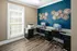 Resident business center featuring a brightly lit workspace with computer stations, a printer, modern black chairs, and decorative wall art at Abberly Woods Apartments in Charlotte, NC