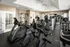 Fully equipped fitness center featuring cardio machines, including treadmills and recumbent bikes, strength training equipment, and mirrored walls for workout versatility at Abberly Woods Apartments in Charlotte, NC