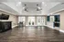 Spacious resident activity center featuring a wall-mounted TV, cozy fireplace, high-top dining area, and access to a modern kitchen at Abberly Woods Apartments in Charlotte, NC at Abberly Woods Apartments in Charlotte, NC