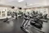 Bright and modern fitness center featuring a variety of cardio machines, including treadmills and ellipticals, along with strength training equipment, free weights, and mirrored walls at Abberly Woods Apartments in Charlotte, NC